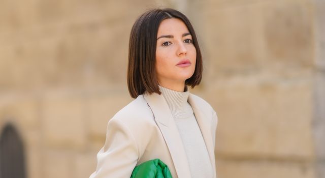 paris, france   october 19 alexandra pereira wears silver earrings, a beige turtleneck pullover, matching beige wool large pants, a beige blazer jacket, a green shiny leather quilted handbag,  rings, on october 19, 2021 in paris, france photo by edward berthelotgetty images