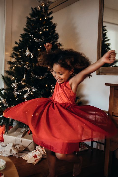 little girl dancing in red christmas eve dress