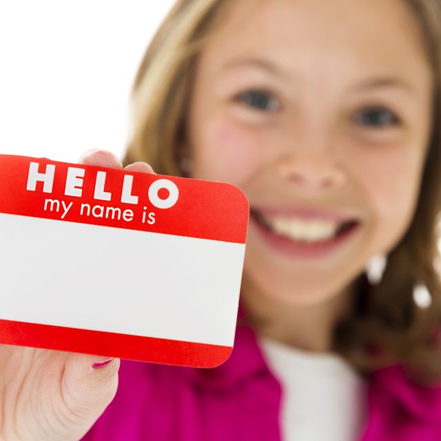 little girl holding nametag