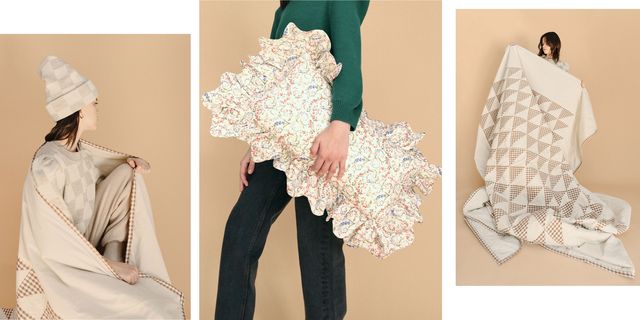 a model carries loeffler randall home decor including a patchwork quilt and ruffled pillow made from deadstock fabrics in front of a plain backdrop