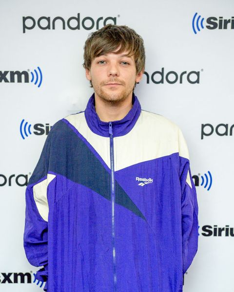 louis tomlinson wears a tracksuit on the red carpet