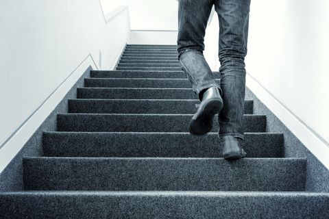 Low Section Of Man Walking On Stairs