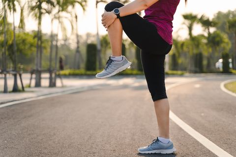 low section of woman exercising on road