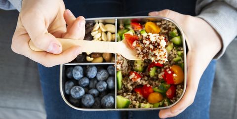 lunchbox with quinoa salad with tomato and cucumber, blue berry and trail mix