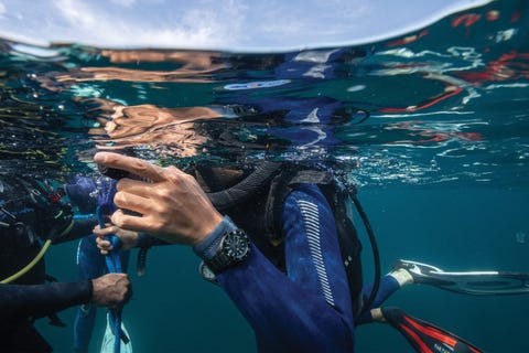 a person on the surface of water scuba diving