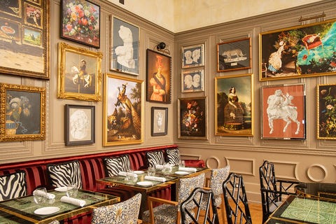 dining room with eclectic zebra print furniture and vintage pictures in gold frames