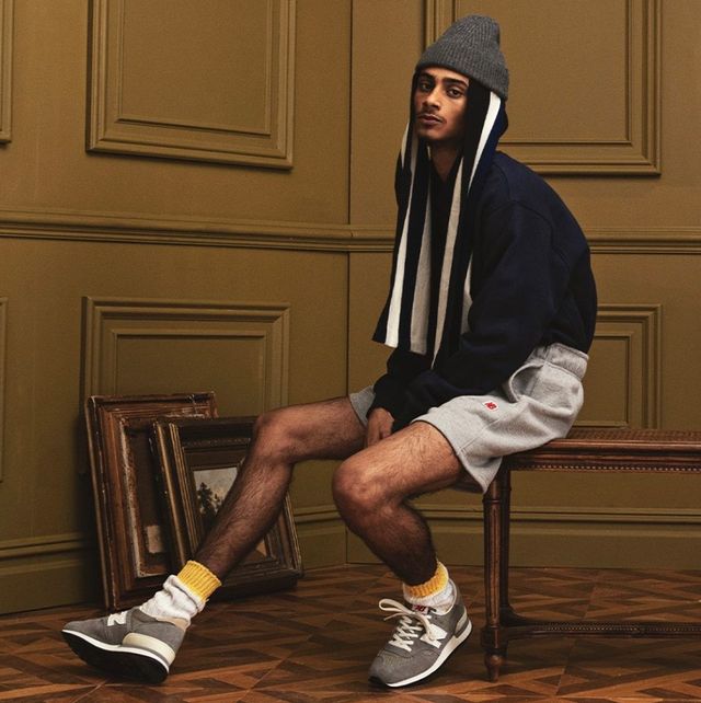 model sitting in a chair wearing new balance made in usa