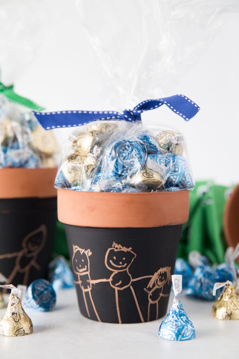 candy filled clay pot with child's drawing of family on it