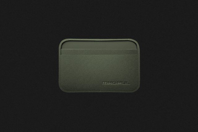 a thin green wallet on a black background