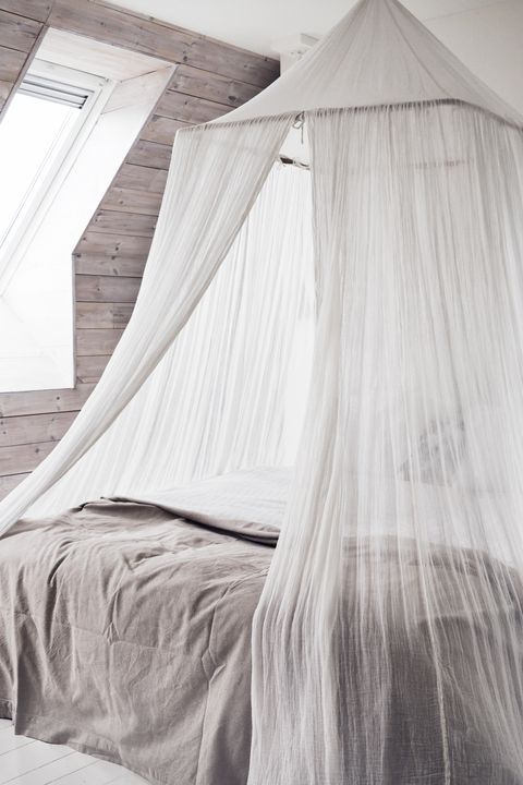 minimalist scandinavian bedroom with sheer canopy