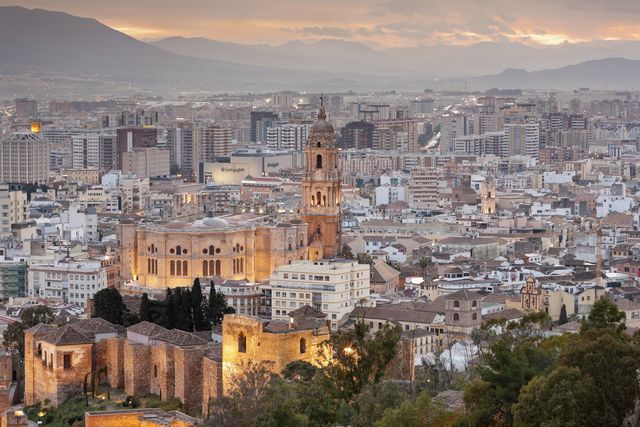 malaga cathedral and the city at dusk, andalucia, spain