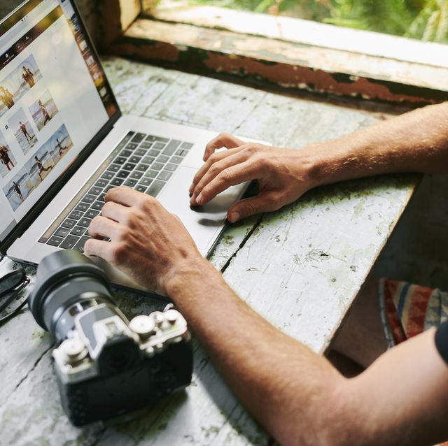 male on laptop in beach hut