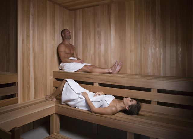 man and woman in sauna at spa