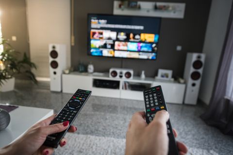 man and woman with television remote control