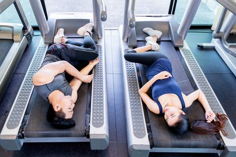 Man and women working out in gym together