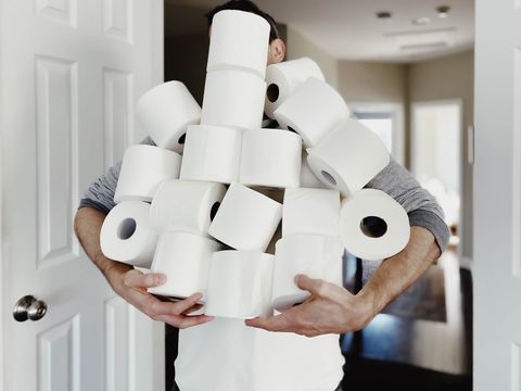 man carries heap of toilet paper