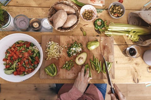 Man chopping vegetables in the kitchen, top view