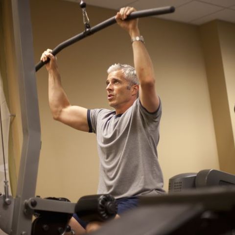 man concentrates on his work out in a gym