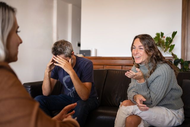 man doing a sad gesture during couple's therapy with a psychologist