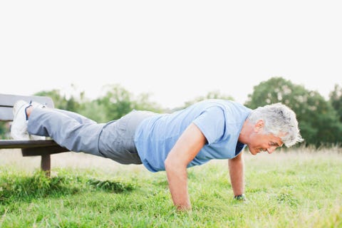 Man doing push-ups in field