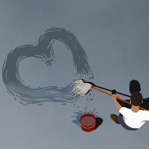 man drawing heart shape with mop