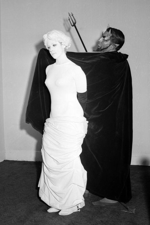 vintage halloween costumes woman dressed as armless sculpture and man dressed as devil