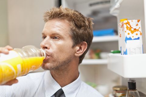 Man drinking juice out of bottle