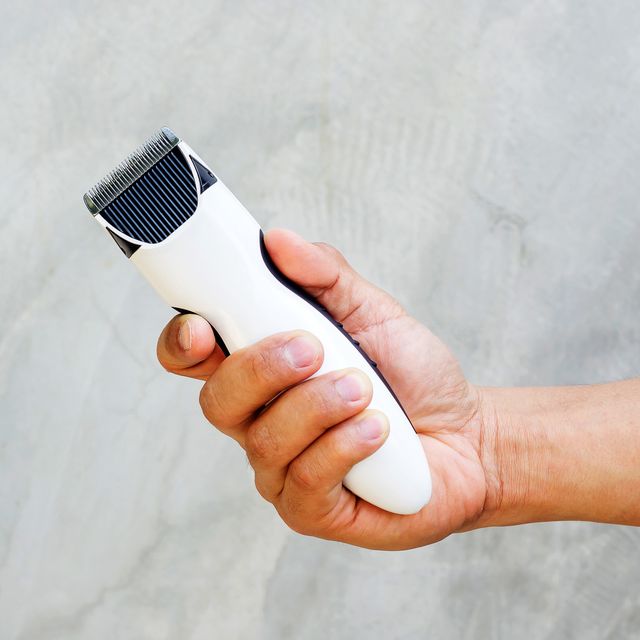 man holding wireless hair clipper in his hand