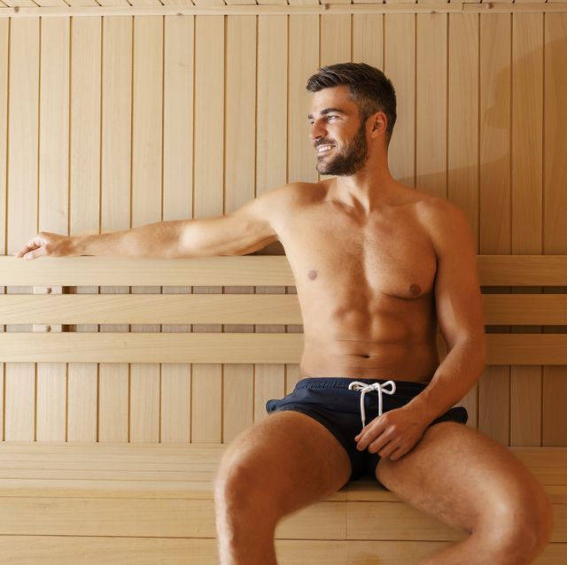 a man in a hot sauna happy muscular macho man sitting in sauna in spa center and relaxing wellness and spa
