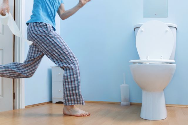 man in night clothes running to toilet