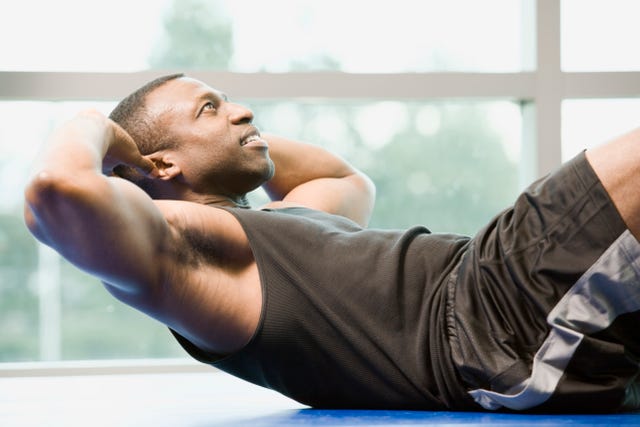 man is doing sit ups at a gym