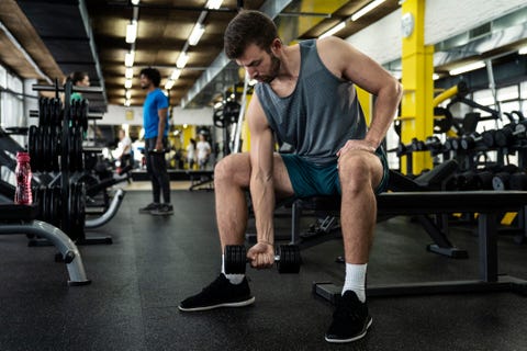 man lifting dumbbell