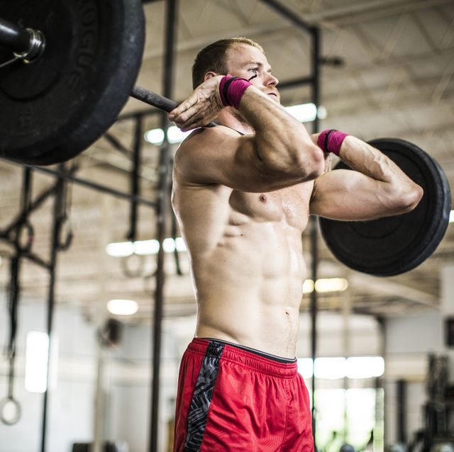 man lifting weights at gym gym
