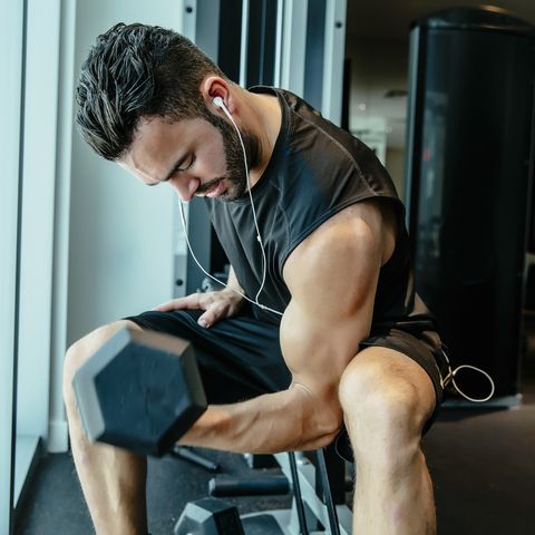 Man lifting weights in gymnasium
