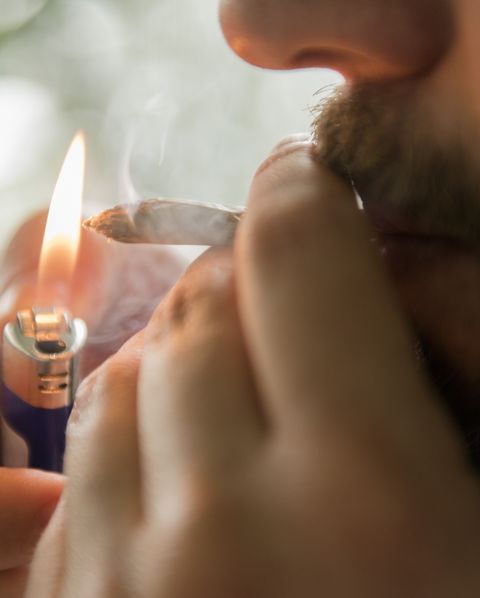 Man lighting marijuana joint