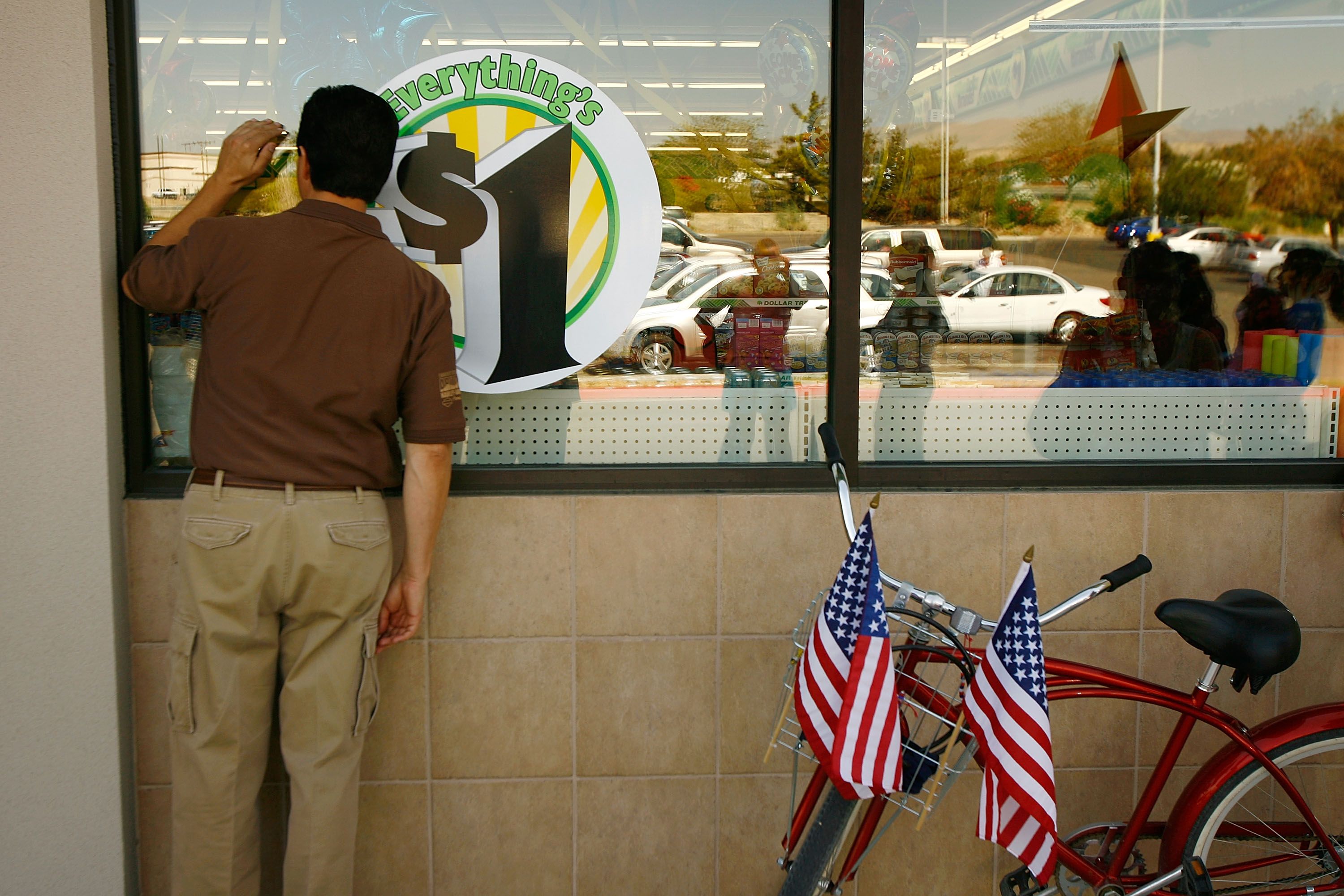 man looks in to the window of a discount store on its grand news photo 1584203748