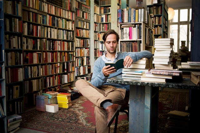 Man reading books in bookstore man reading books in bookstore