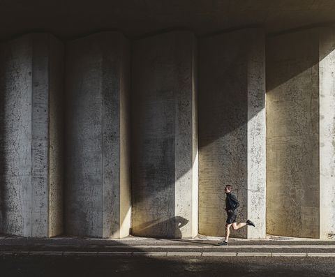 Man running in concrete underpass