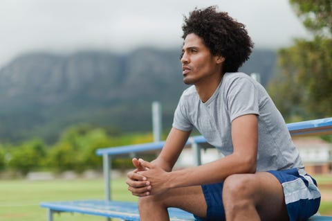 Man sitting on bleachers in park