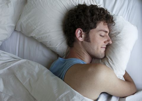 a man sleeps hugging his pillow