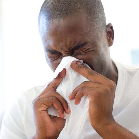 Man sneezing, eyes closed man sneezing, eyes closed