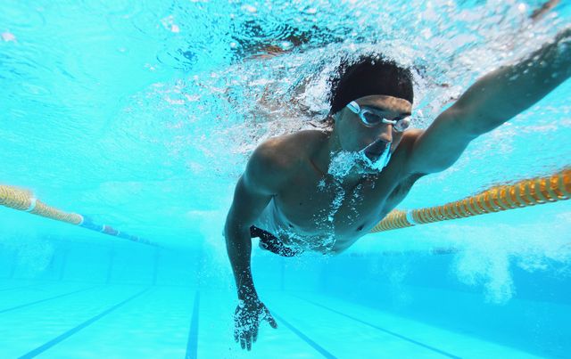 man swimming in pool, underwater