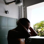 Man taking shower in bathroom man taking shower in bathroom
