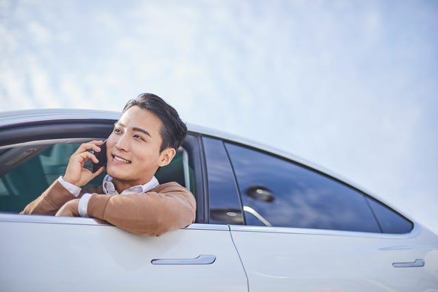 a man talking through a phone while driving