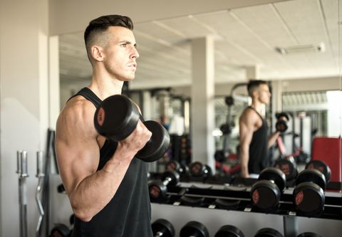 Man training biceps in gym