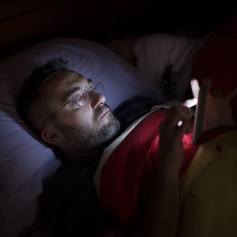 man using his smart phone in the dark