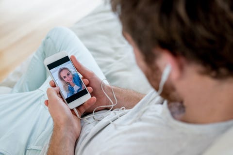Man video chatting on his cell phone Man video chatting on his cell phone