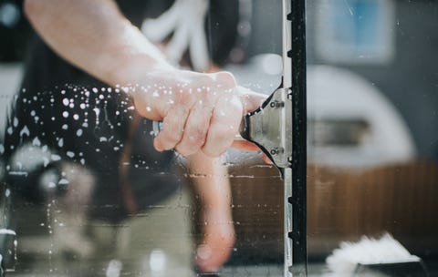 man washing window