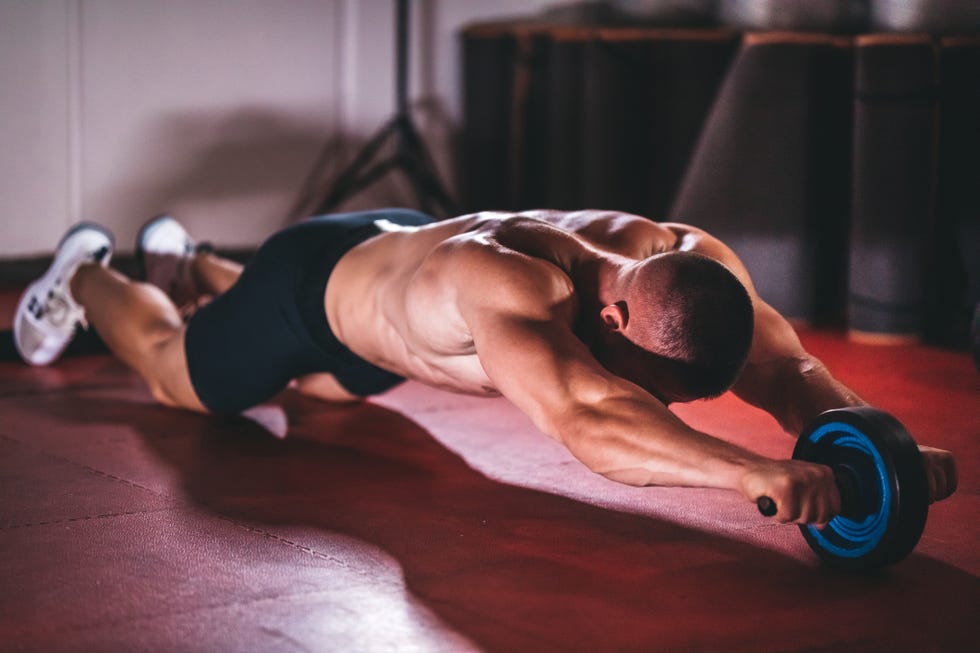 Man work out with ab roller.