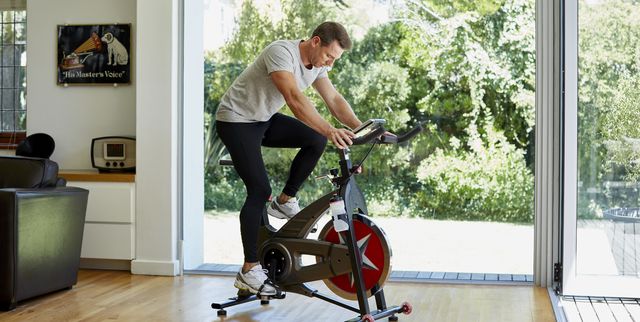 man working out on exercise bike at home